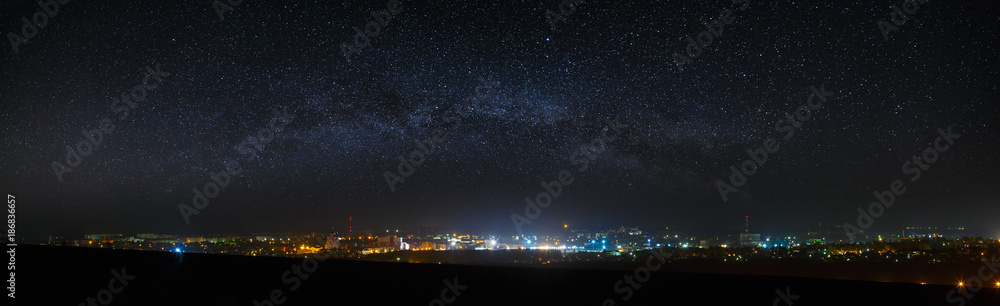Panoramic view of the starry night sky above the city. - obrazy, fototapety, plakaty 