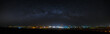 Panoramic view of the starry night sky above the city.