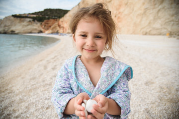 Wall Mural - Girl Holding Beach Stones in Head