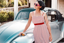 Woman Posing By Iconic Classic Car