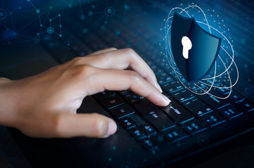 Press enter button on the keyboard computer Shield cyber Key lock security system abstract technology world digital link cyber security on hi tech Dark blue background, lock finger Keyboard