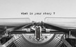 Leinwandbild Motiv What is your story typed words on a Vintage Typewriter
