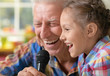 © aletia2011 - grandfather and child singing karaoke
