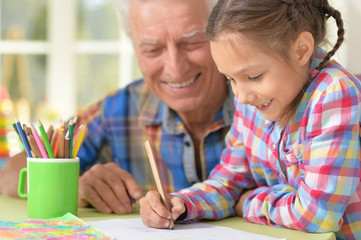 Canvas Print - Grandfather with granddaughter drawing together