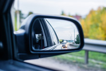 The Reflection Of The Road With Cars In The Rearview Mirror Car Traffic In The Evening Background Backdrop