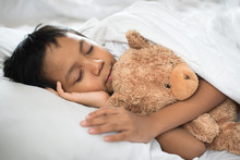 Boy Sleeping On Bed With Teddy Bear White Pillow And Sheets.boy Fall Asleep In Morning.sleep Concept