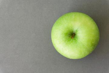 Wall Mural - Closeup tov view green fresh apples fruit on grey background , healthy diet food concept