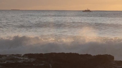 Wall Mural - shorebreak ocean waves near rocky coast and cliffs, rough sea water at sunset time
