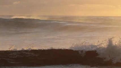 Wall Mural - shorebreak ocean waves near rocky coast and cliffs, rough sea water at sunset time