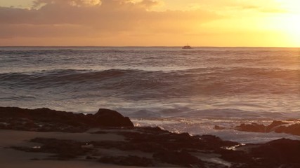 Wall Mural - shorebreak ocean waves near rocky coast and cliffs, rough sea water at sunset time