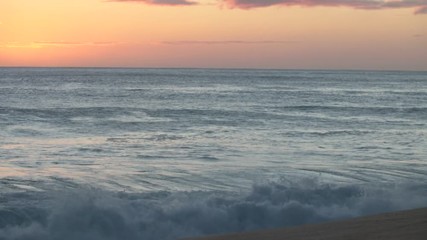 Wall Mural - shorebreak ocean waves near rocky coast and cliffs, rough sea water at sunset time