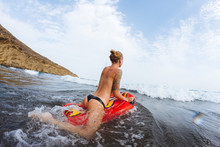 Young Topless Girl In Thongs On Pool Float In Ocean Waves