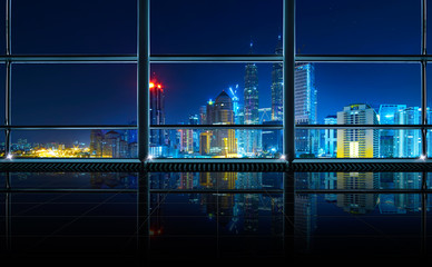 Wall Mural - Modern empty and clean office interior with glass windows , Kuala Lumpur city skyline background , night scene .