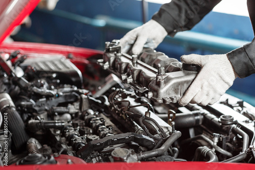 Fotomural Repairing of modern diesel engine, workers hands and tool