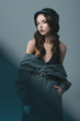 © LIGHTFIELD STUDIOS - elegant girl posing in autumn coat and military helmet, isolated on grey with blue filter