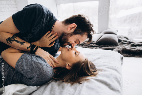 Love Story In Love Couple Hug And Kiss On The Bed Near The