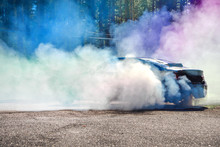 Drift Car Warming Up The Tires Before  Start, Waiting For Race To Begin. Blue And Purple Smoke All Around