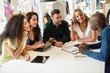© javiindy - Multi-ethnic group of young people studying together on white desk