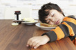 © Westend61 - Portrait of little boy sleeping at breakfast table