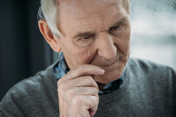 Wall Mural - Senior man with sad expression cries