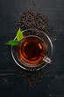 © Yaruniv-Studio - A cup of black tea on a wooden background. Top view. Copy space.