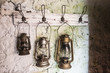© Westend61 - Old vintage storm lamps on stone wall