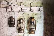 Old Vintage Storm Lamps On Stone Wall