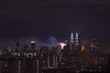 KUALA LUMPUR, MALAYSIA - 1ST JANUARY 2018; Fireworks explode near Malaysia's landmark Petronas Twin Towers during New Year celebrations in Kuala Lumpur.