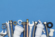 Plumbing tools and equipment overhead view on a blue background