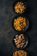 © Natasa Mandic/Stocksy - Different kind of pasta on dark background