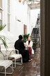 © Guille Faingold/Stocksy - Elegant woman talking to man in black.