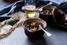 Beef And Mushroom Stew Served In Individual Bowls.
