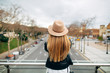© Javier Pardina/Stocksy - woman using phone on the street