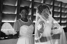 An African Bride And Her Bridesmaid Look A Little Nervous As They Wait To Enter The Church.