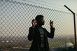 © Javier Pardina/Stocksy - African man behind an iron grid