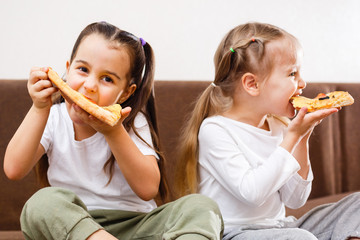 Young girls eating pizza