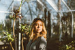 © Luke Mattson/Stocksy - Portrait Of Young Beautiful Asian American Woman In Greenhouse