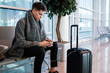 © Susana Ramâ€™rez/Stocksy - Young man at the airport