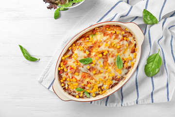 Wall Mural - Baking dish with corn pudding on table, top view