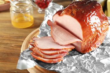 Poster - Board with sliced honey baked ham on table, closeup