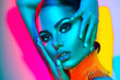 © Subbotina Anna - Fashion model woman in colorful bright lights with trendy makeup and manicure posing in studio