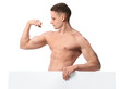 © Africa Studio - Muscular young bodybuilder with blank poster on white background
