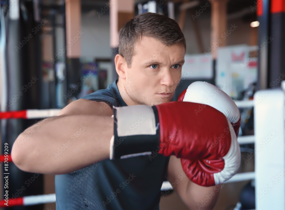 Young man training in boxing ring