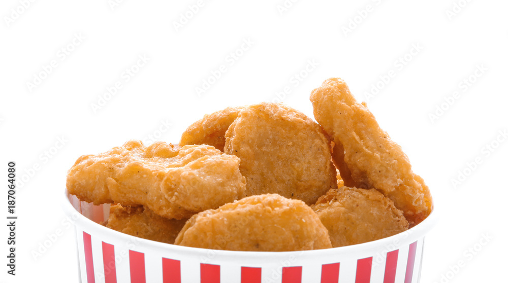 Paper cup with tasty chicken nuggets on white background