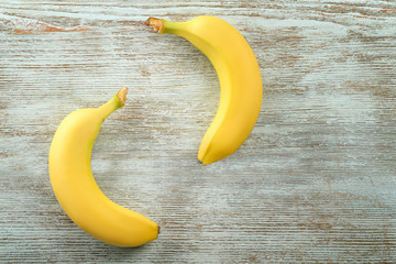 Two ripe bananas on wooden background