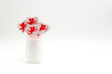 Small Mason Jar Filled With Bright Red Cupid Cupcake Picks Isolated On A Solid Background