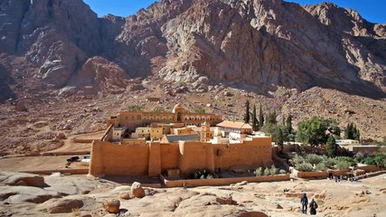 Sticker - The medieval citadel is the Sacred Monastery of the God-Trodden Mount Sinai (St Catherine's), located in desert gorge, at mountain foot, surrounded by tall ramparts and monastic garden, Sinai, Egypt.