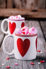 Sticker - Hot coffee with pink marshmallow in mugs with hearts for Valentine's day