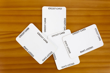 Wall Mural - Credit card blanks scattered on wood table.