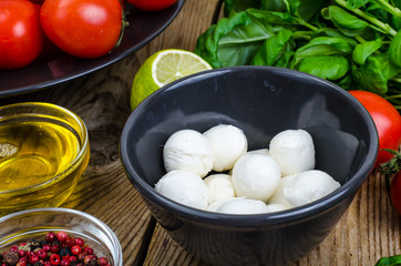 Wall Mural - Mozzarella, basil, tomatoes, olive oil-ingredients for caprese